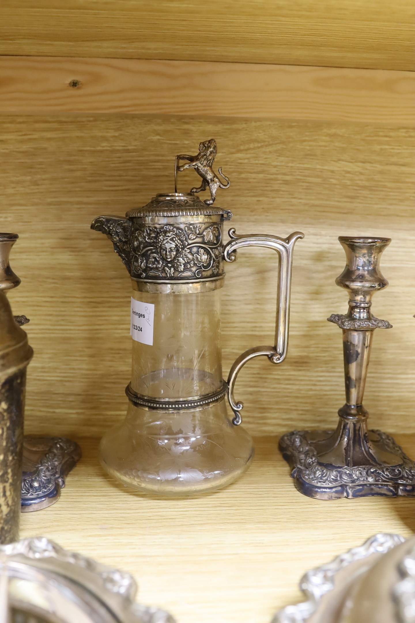 A group of mixed plated wares including tureen, cocktail shaker, claret jug, candlesticks etc.